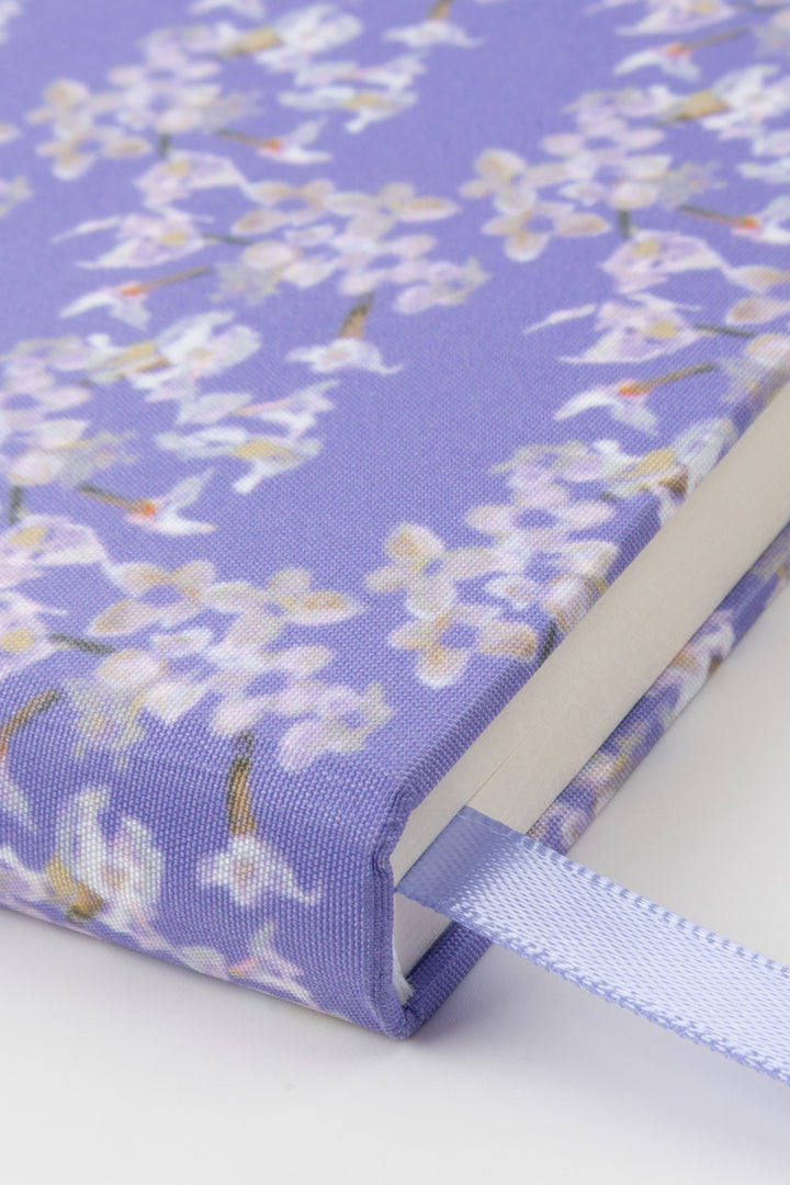 Journal with a floral design on a purple background