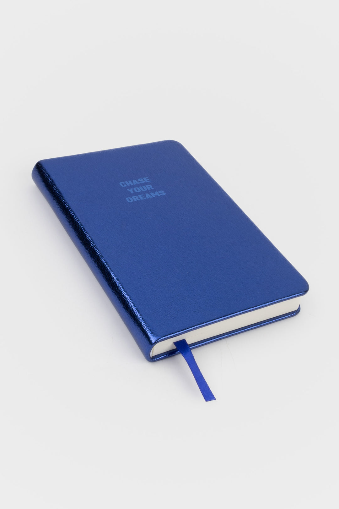 A6 metallic blue notebook angled with the ribbon marker visible at the bottom
