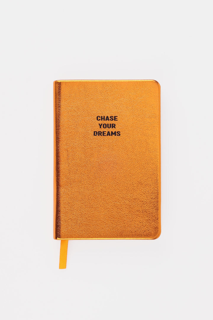 A6 metallic orange notebook with Chase Your Dreams text on the cover
