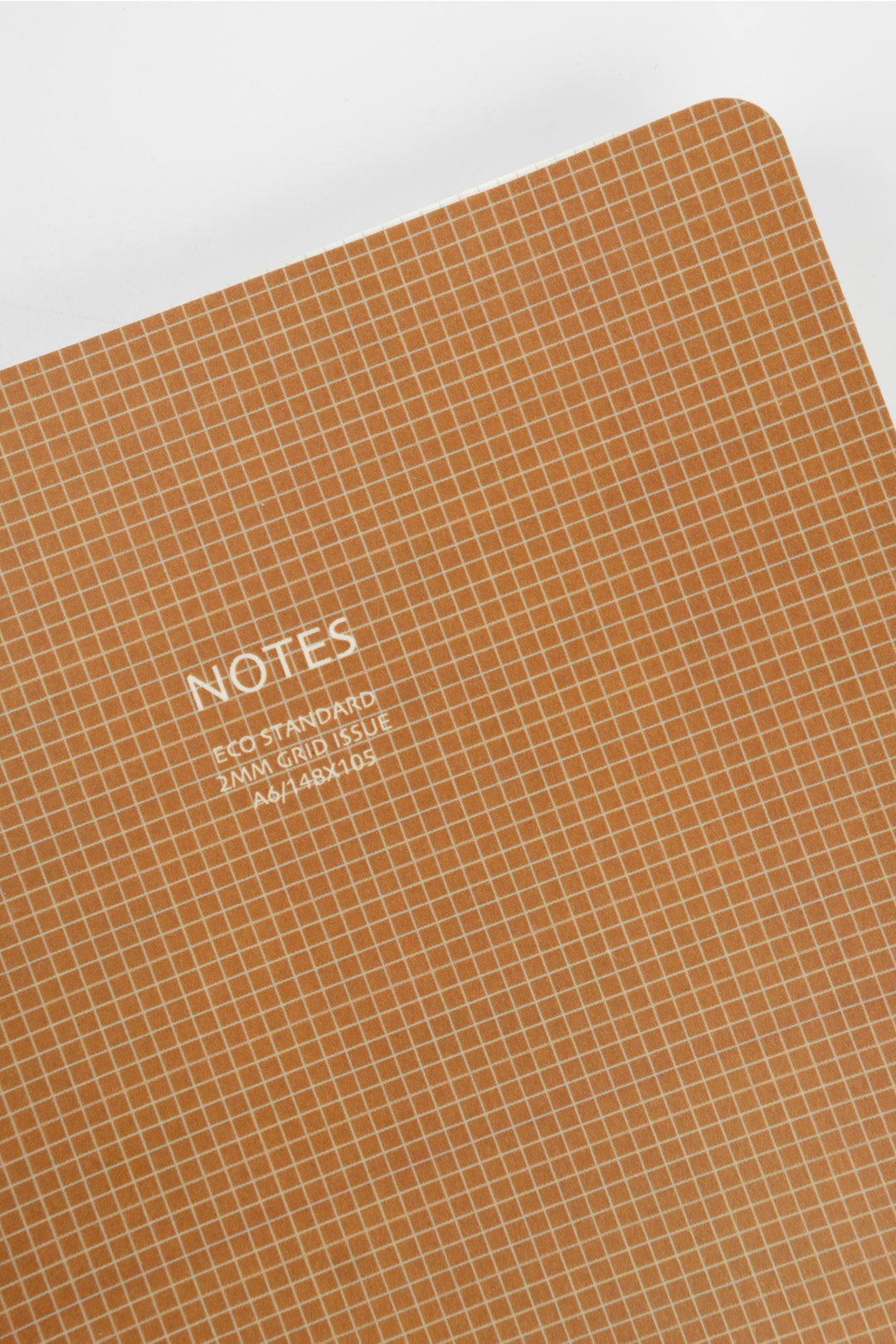 Notebook with grid pattern and 'NOTES' text on a white background