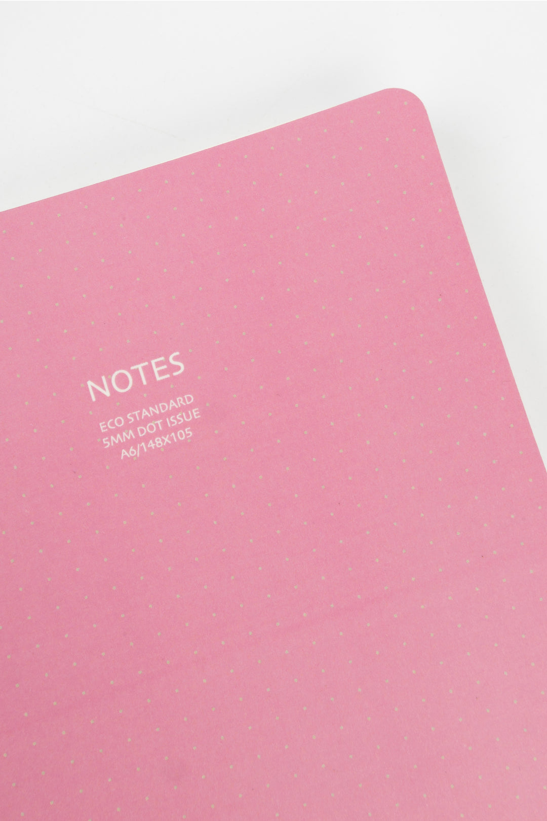 Pink notebook with 'NOTES' text on a white background