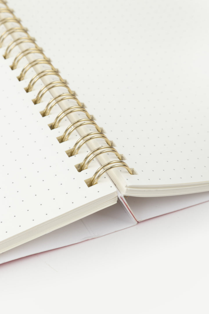 Open notebook with spiral binding on a white background