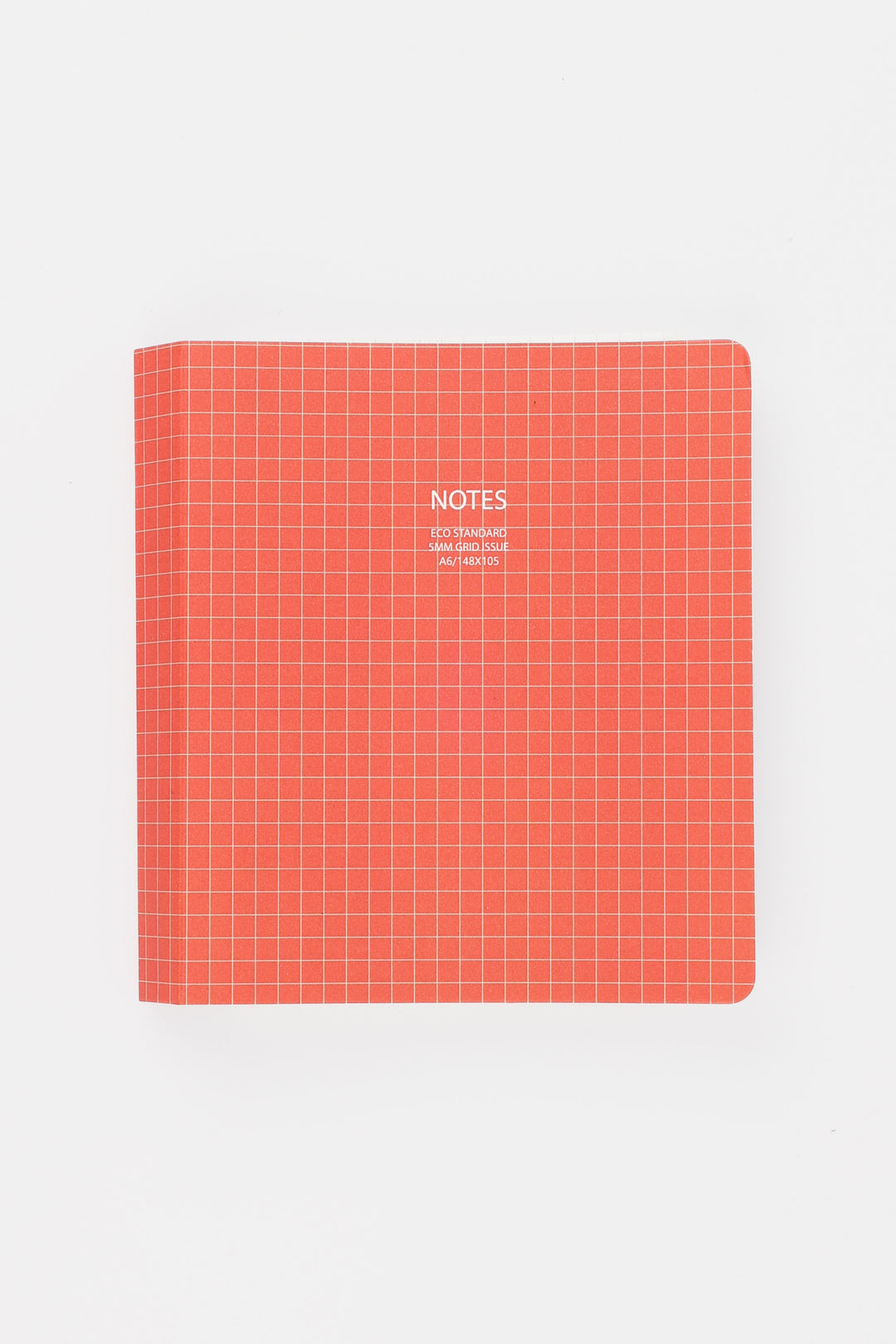 Red notebook with grid pattern and 'NOTES' text on a white background