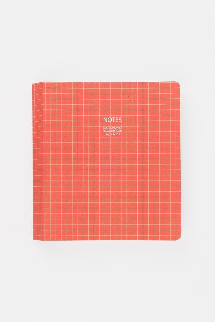 Red notebook with grid pattern and 'NOTES' text on a white background