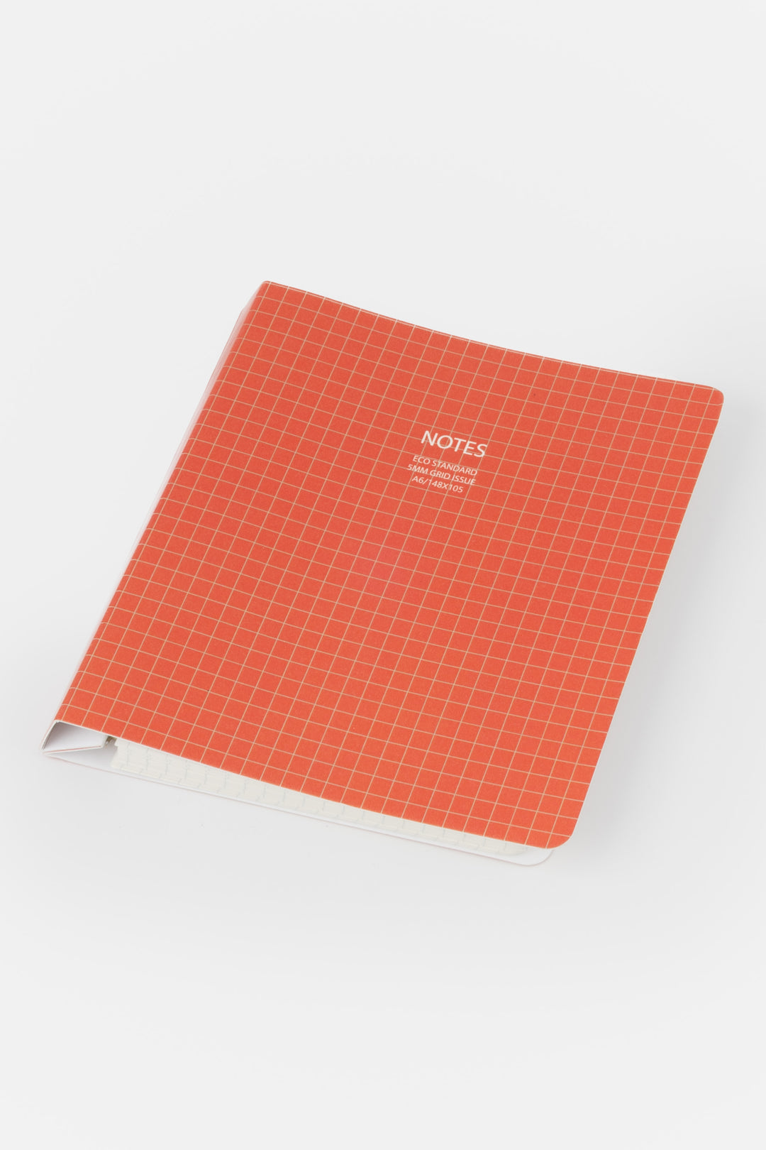 red grid notebook with 'NOTES' text on a white background