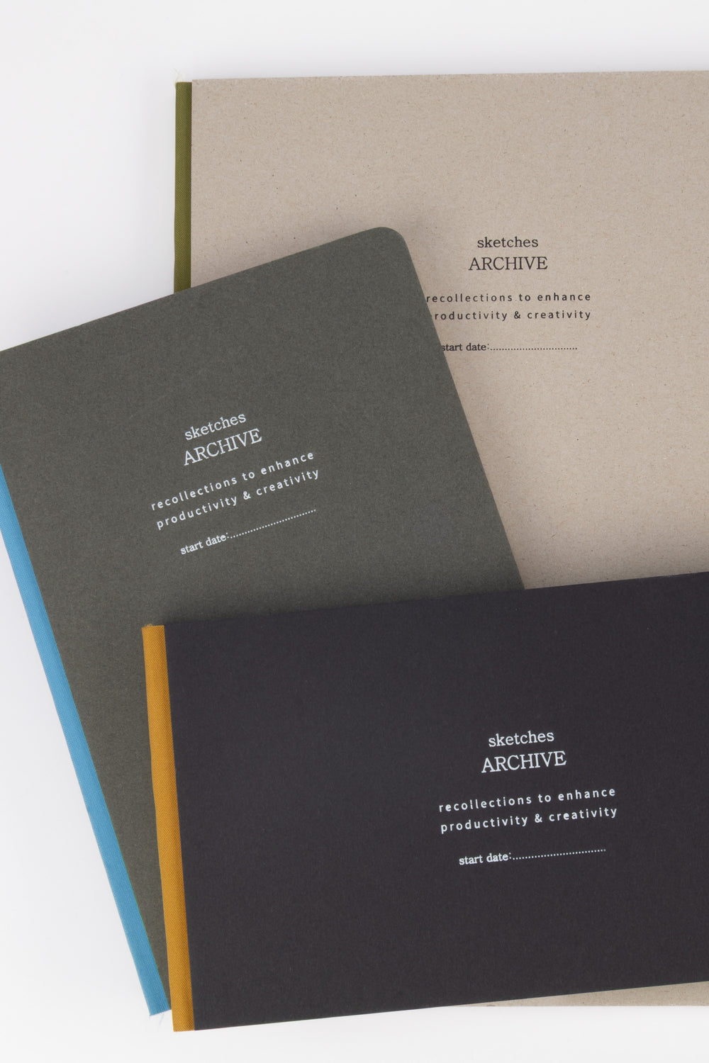 Three sketchbooks with 'sketches ARCHIVE' branding 