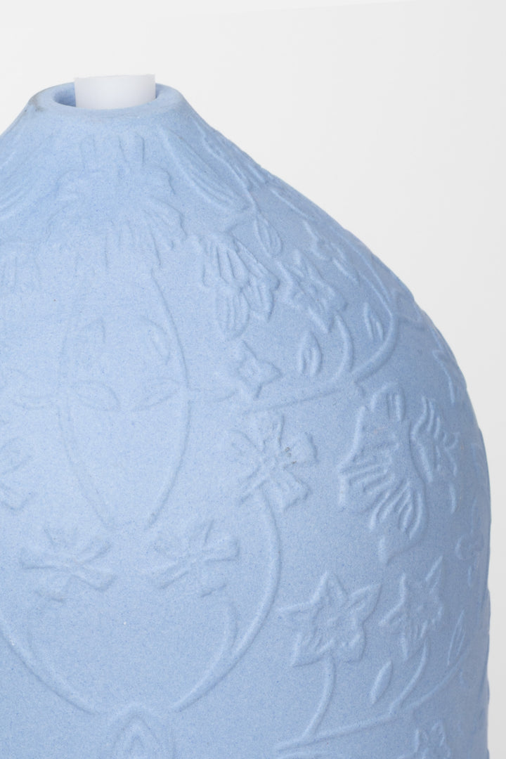 Light blue textured detail of ceramic diffuser on a white background
