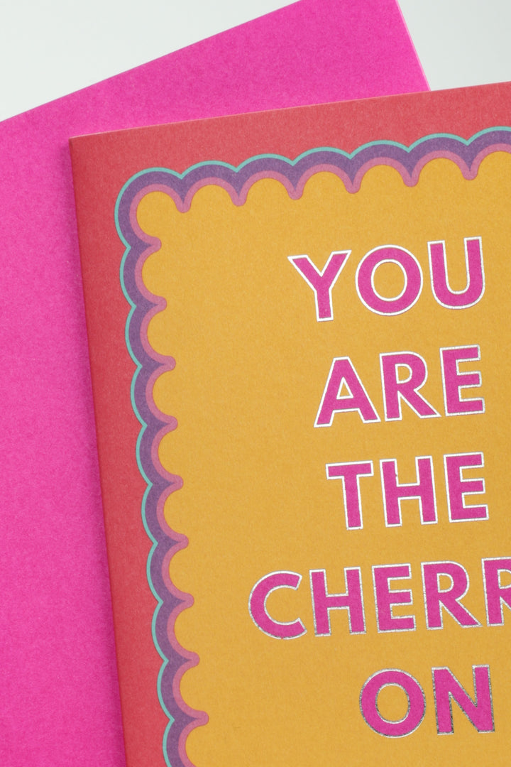 close up of greeting card you are the cherry on top with bright pink envelope underneath
