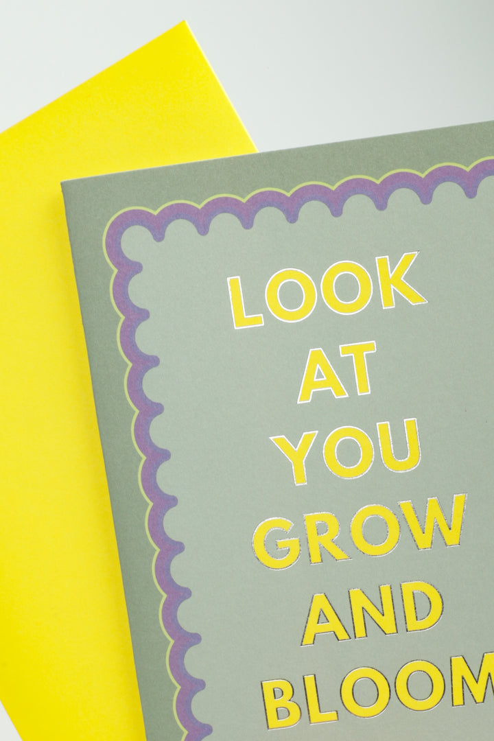 close up of greeting card look at you grow and bloom with bright yellow envelope underneath
