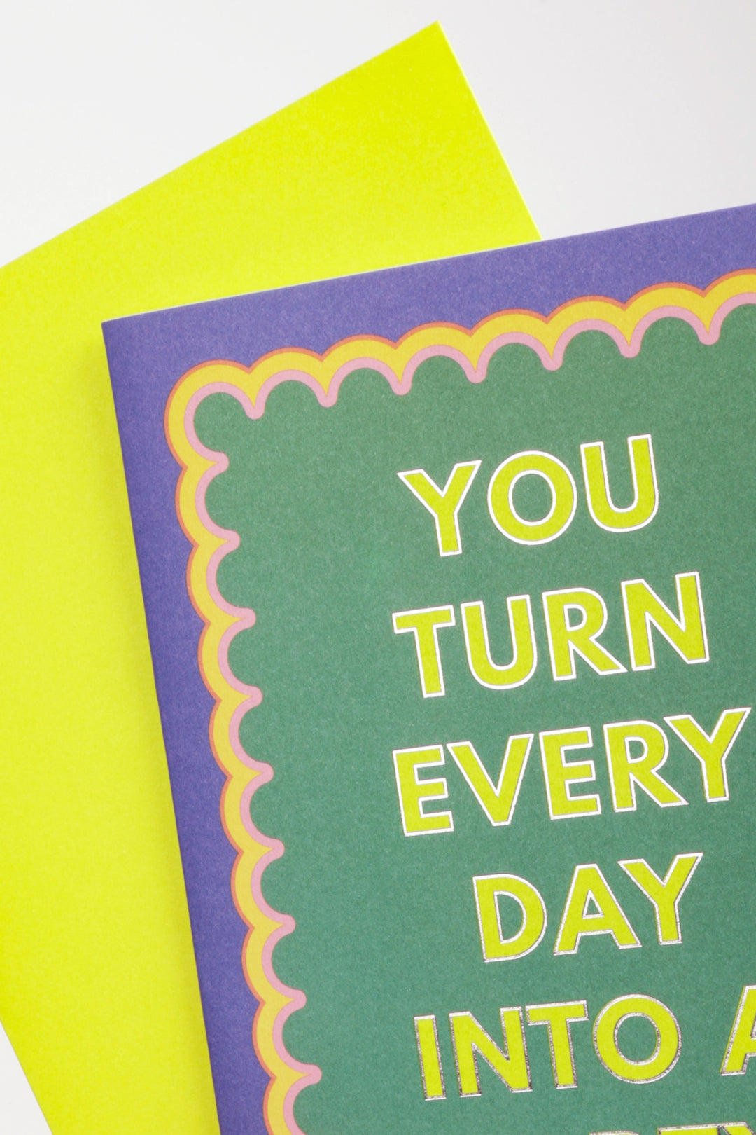 Card with text 'You turn every day into a' on green paper with purple border and yellow text.