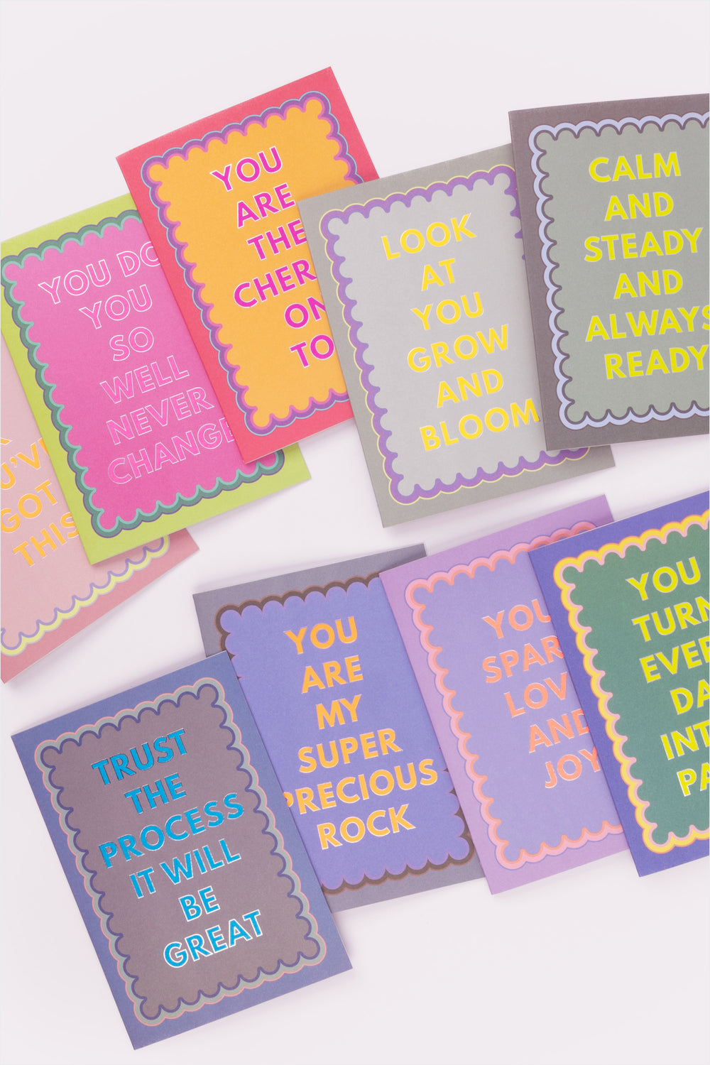 Motivational cards with colorful text on a white background
