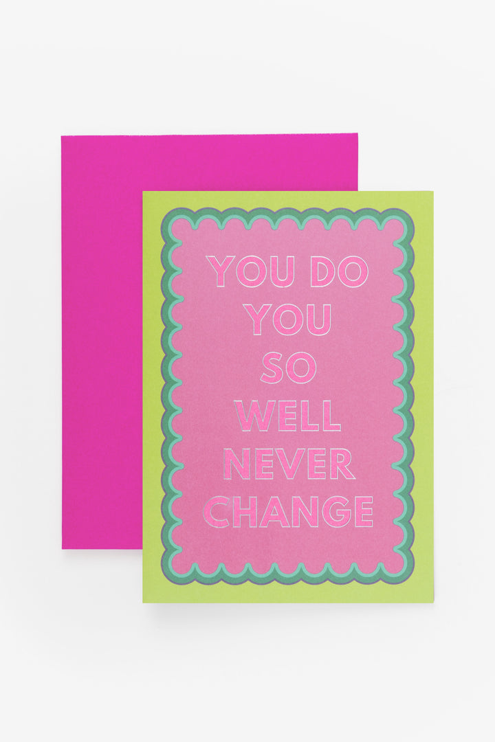 Greeting card with 'You do you so well never change' text on a pink background with green border, next to a pink card on a white background.