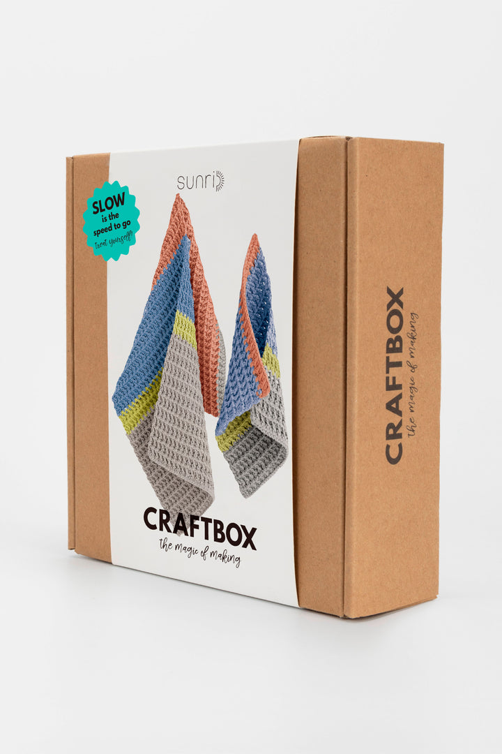 CraftBox packaging with colorful knitted items on a white background