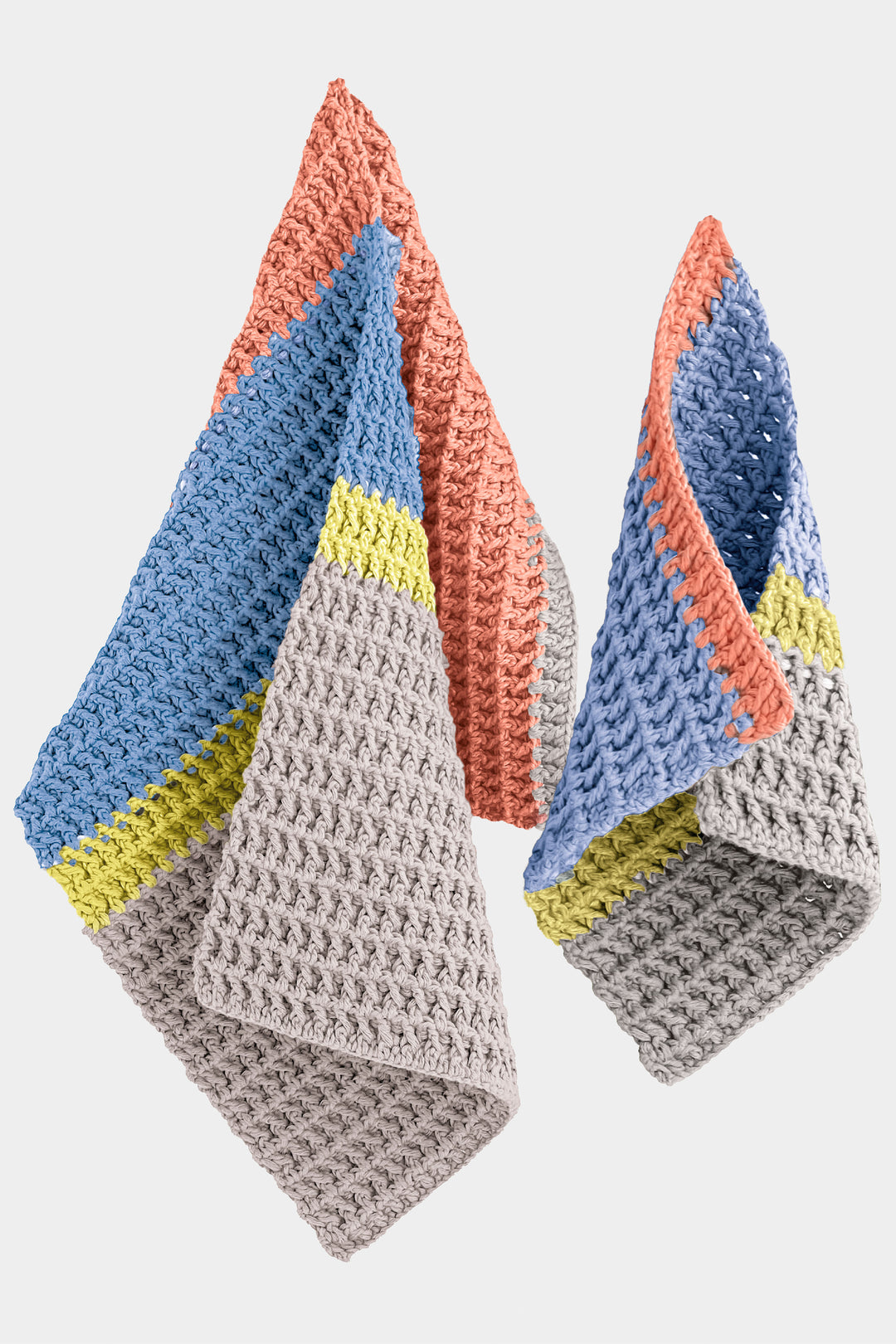Three crocheted guest towels with colorful patterns on a white background