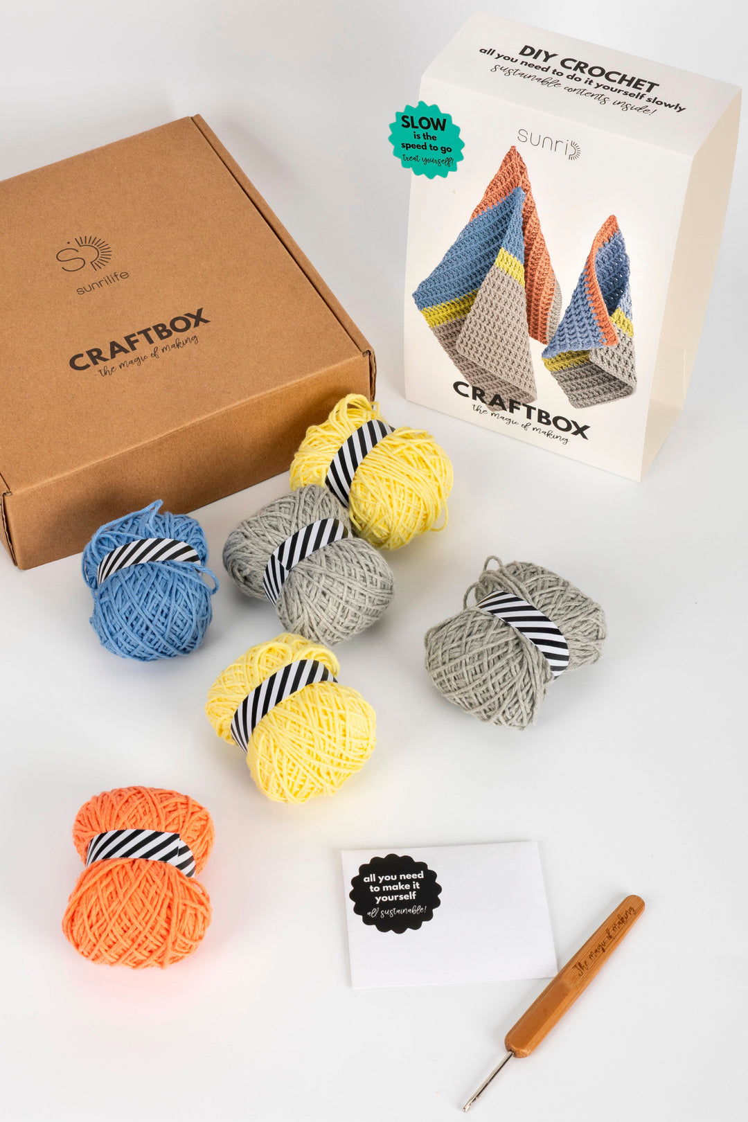 Craftbox DIY crochet kit with yarn balls and a crochet hook on a white background