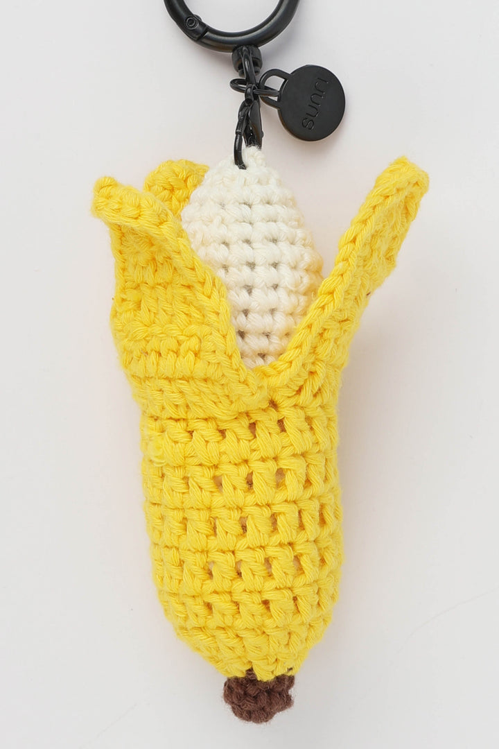 Crocheted banana keychain on a white background