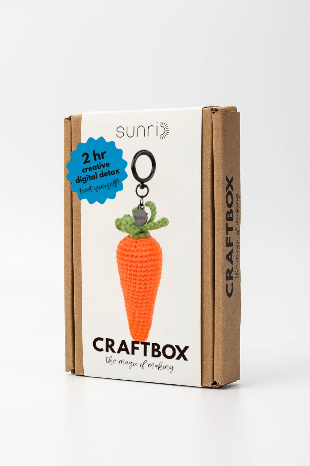 Craft box with a carrot-shaped keychain on a white background