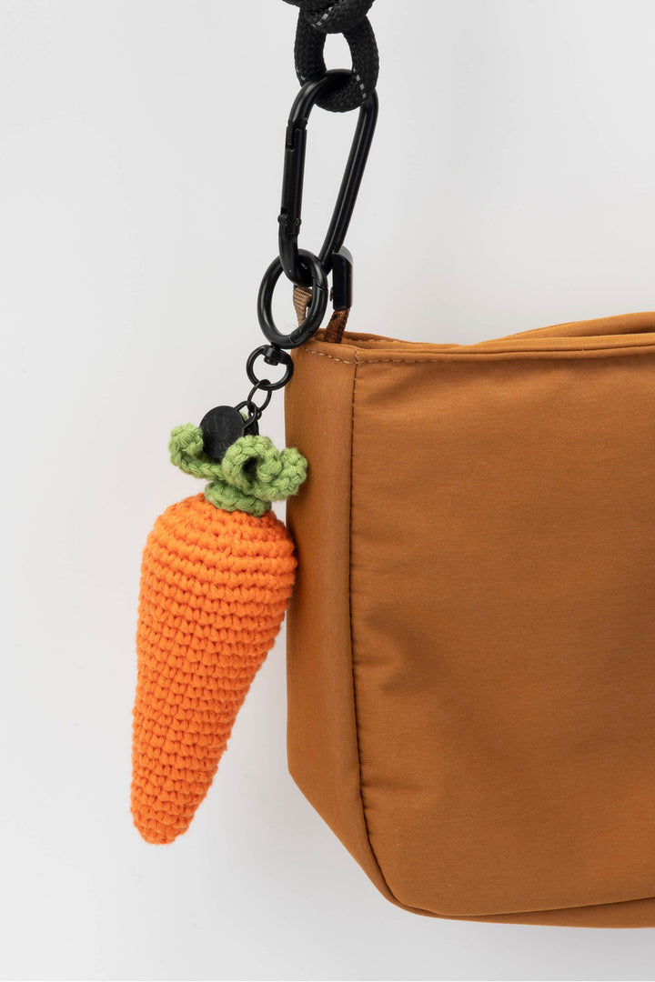 Brown bag with a carrot-shaped keychain on a white background