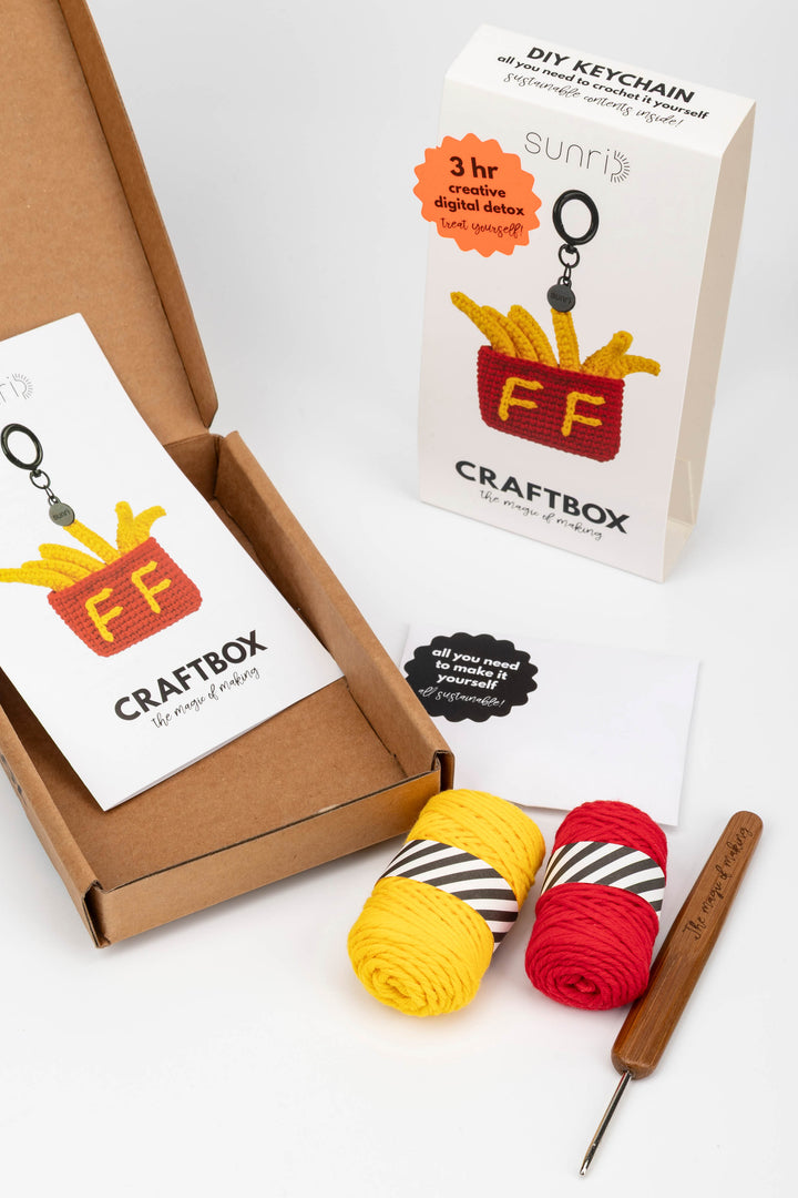 Craft kit with yarn and crochet hook, featuring 'FF' branding on a white background.