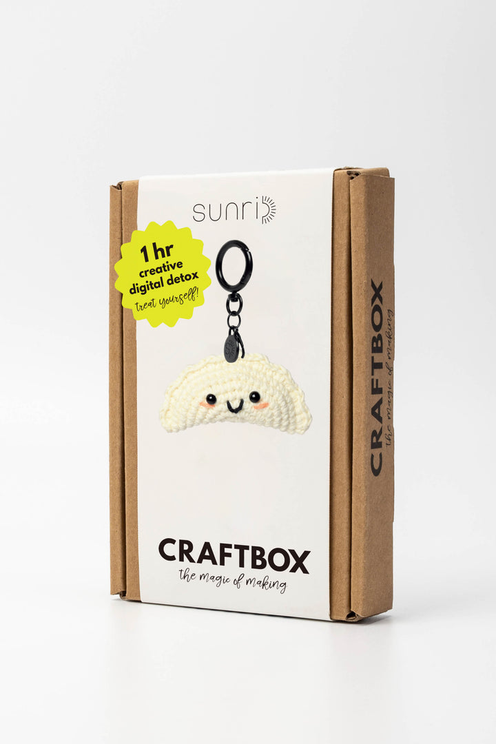 Craft box with a cute white Gyoza keychain on a white background