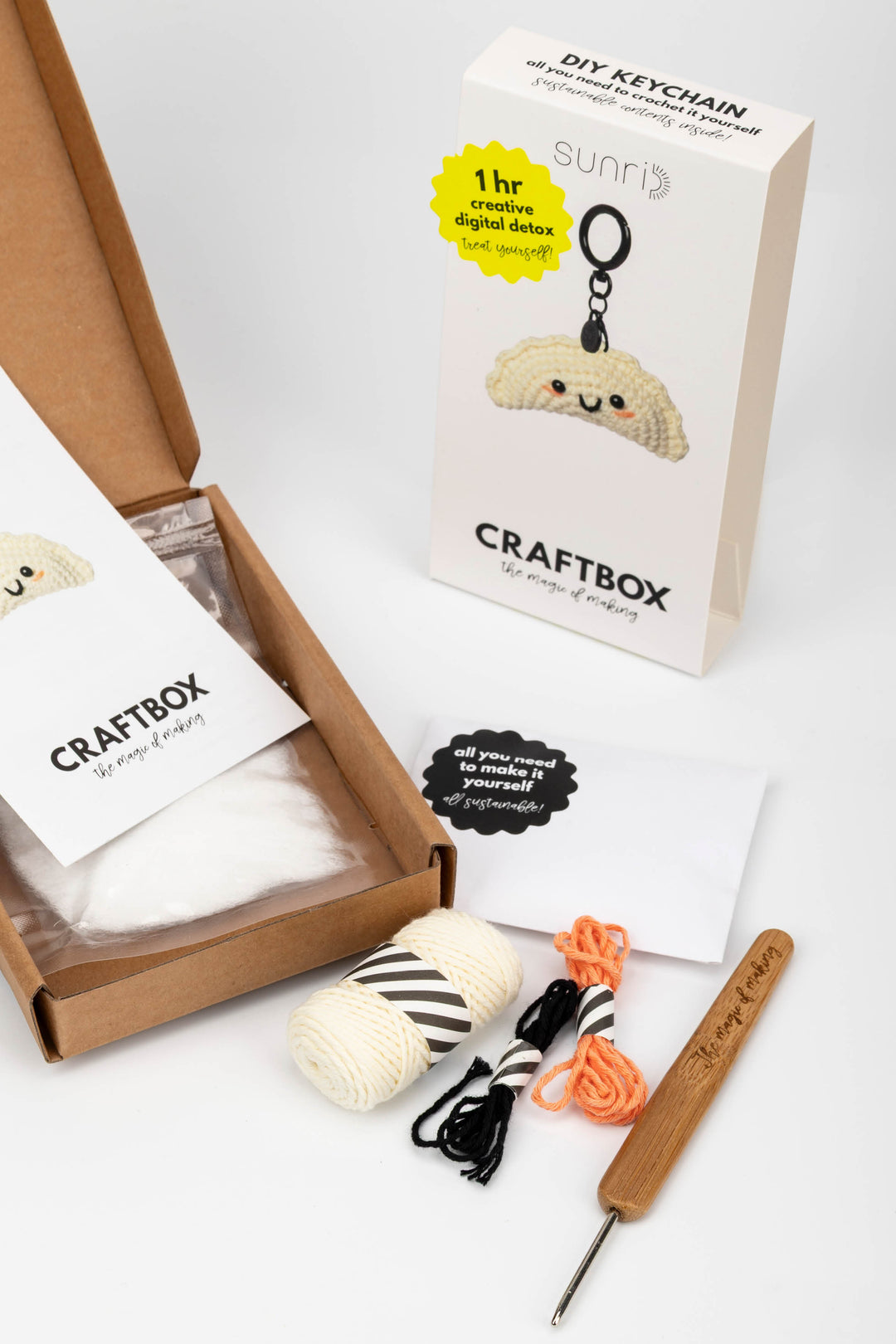 Craft kit with yarn, crochet hook, and keychain in a box labeled 'Craftbox'.