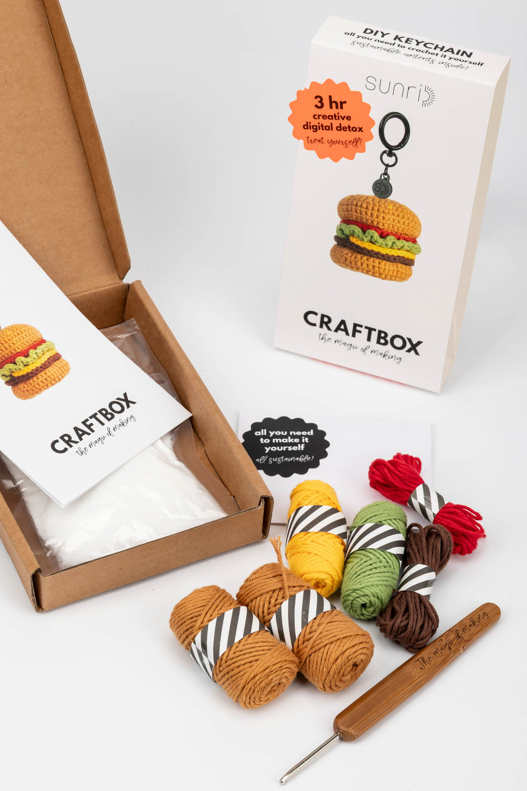 Craftbox with yarn and crochet tools on a white background