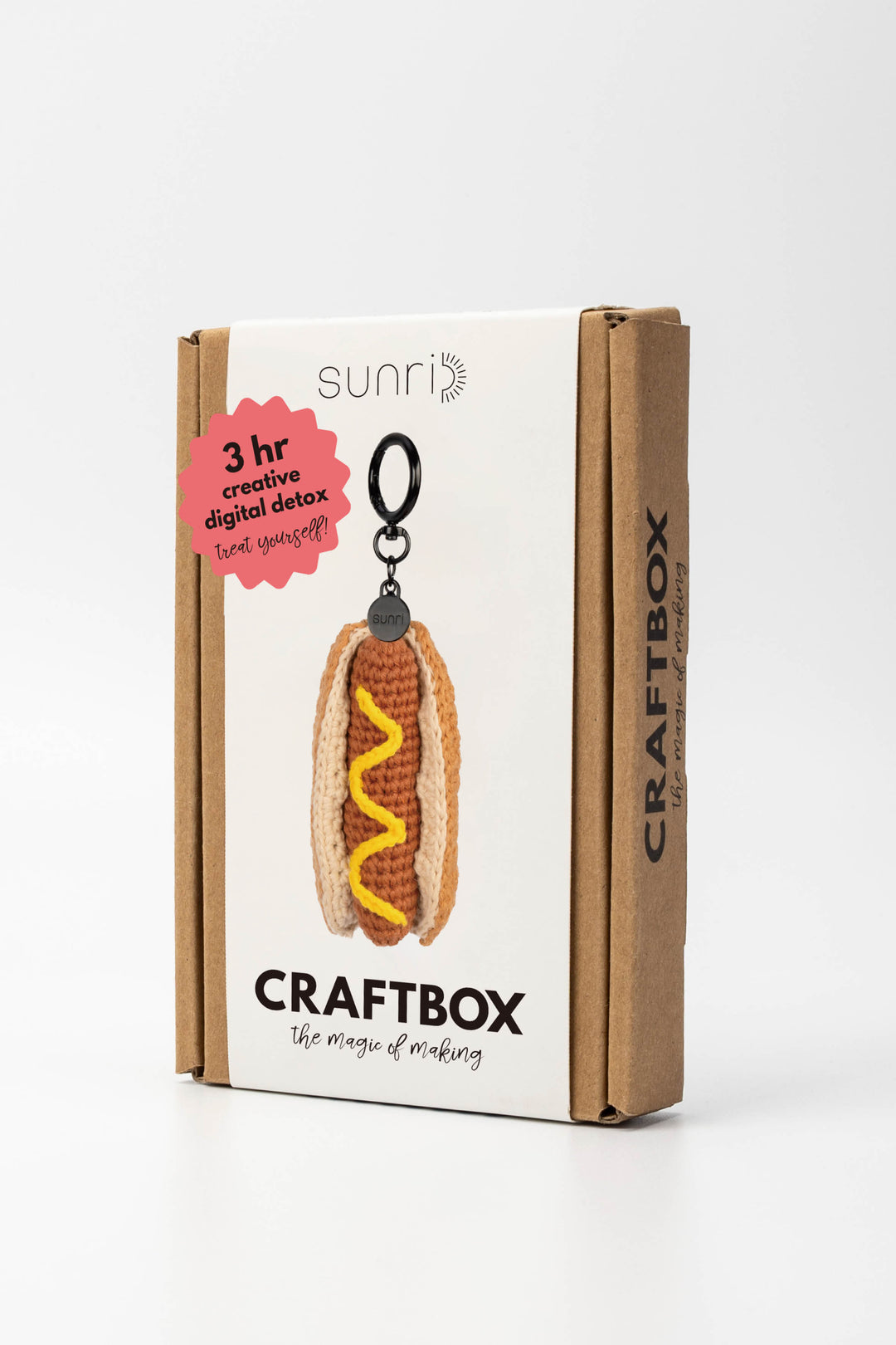 Craft box packaging with a hot dog keychain on a white background