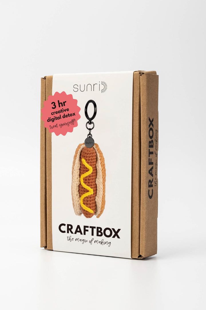 Craft box packaging with a hot dog keychain on a white background