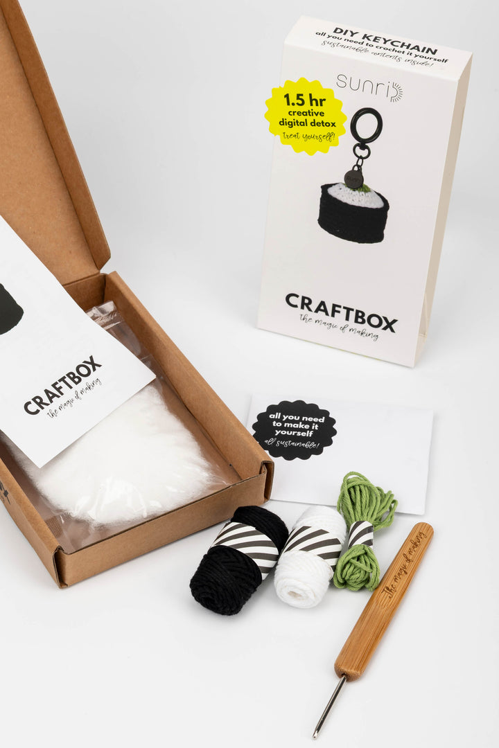 CraftBox with yarn and crochet hook on a white background
