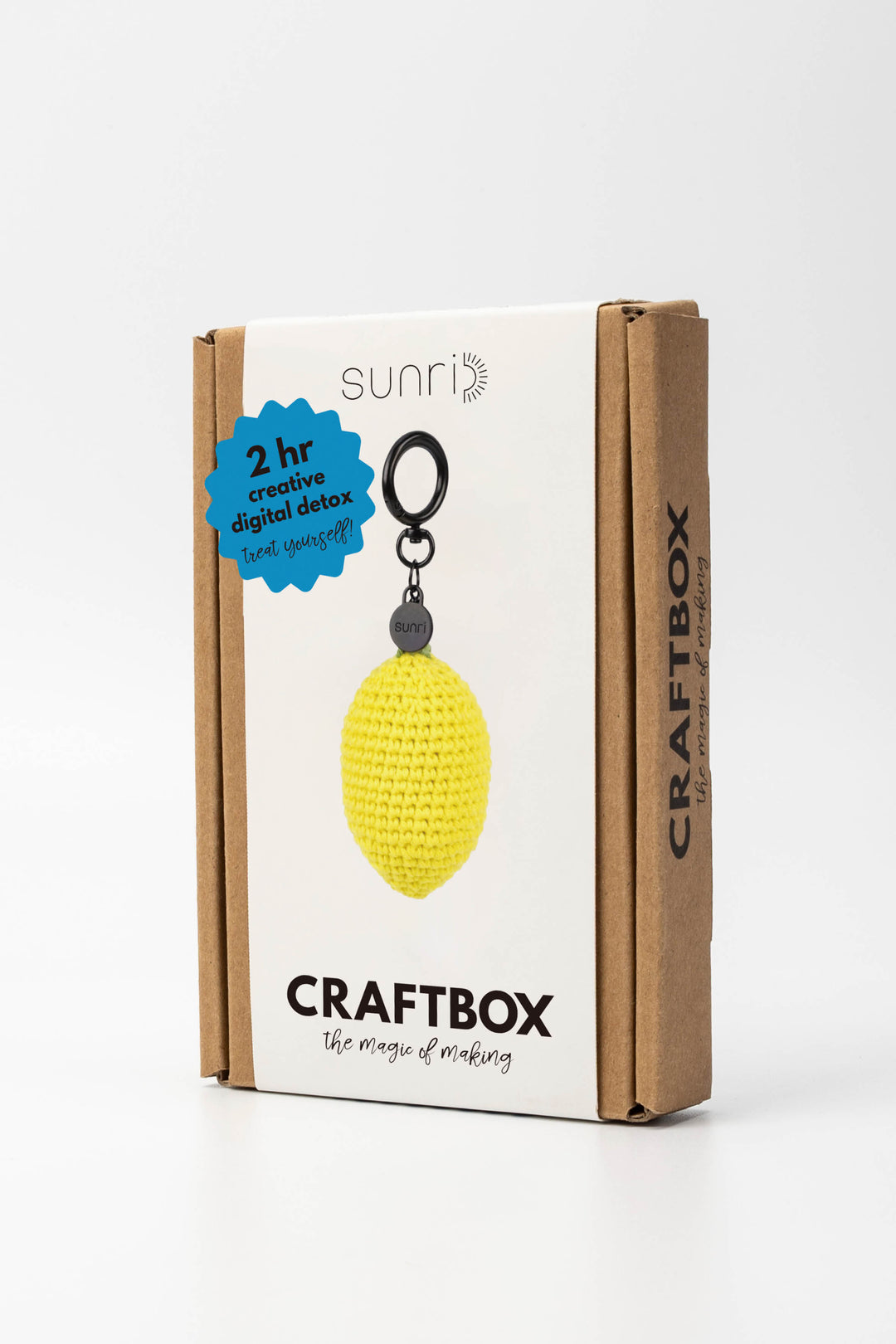 Craft box with a yellow crochet lemon charm on a white background