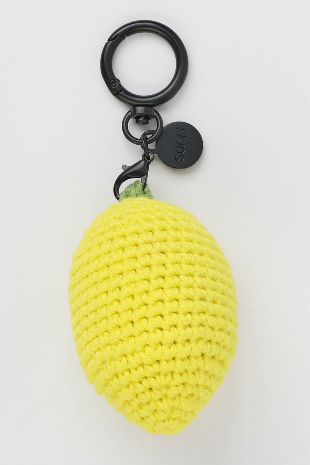 Yellow lemon-shaped keychain with a black ring on a white background