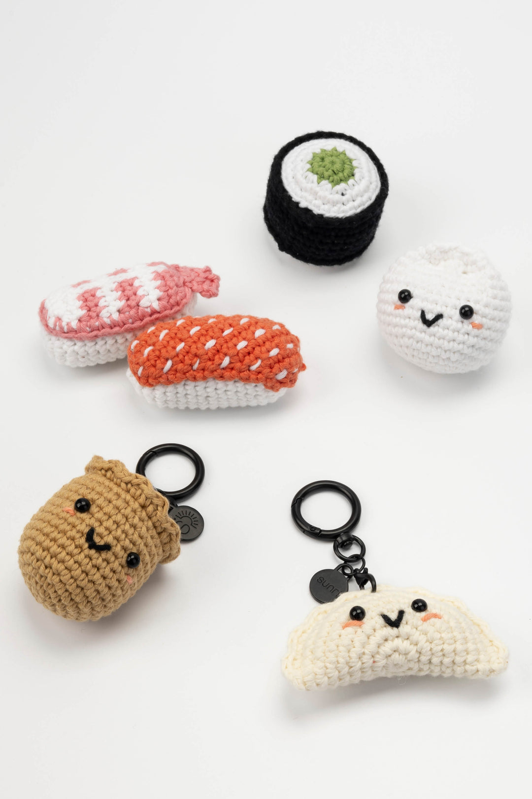 Set of crocheted sushi keychains on a white background