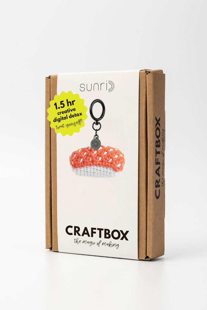 Craft box packaging with a keychain and branding on a white background