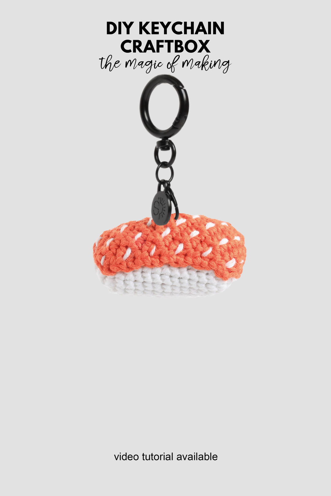 Crocheted sushi keychain with black ring on a white background, featuring text about DIY keychain craftbox.