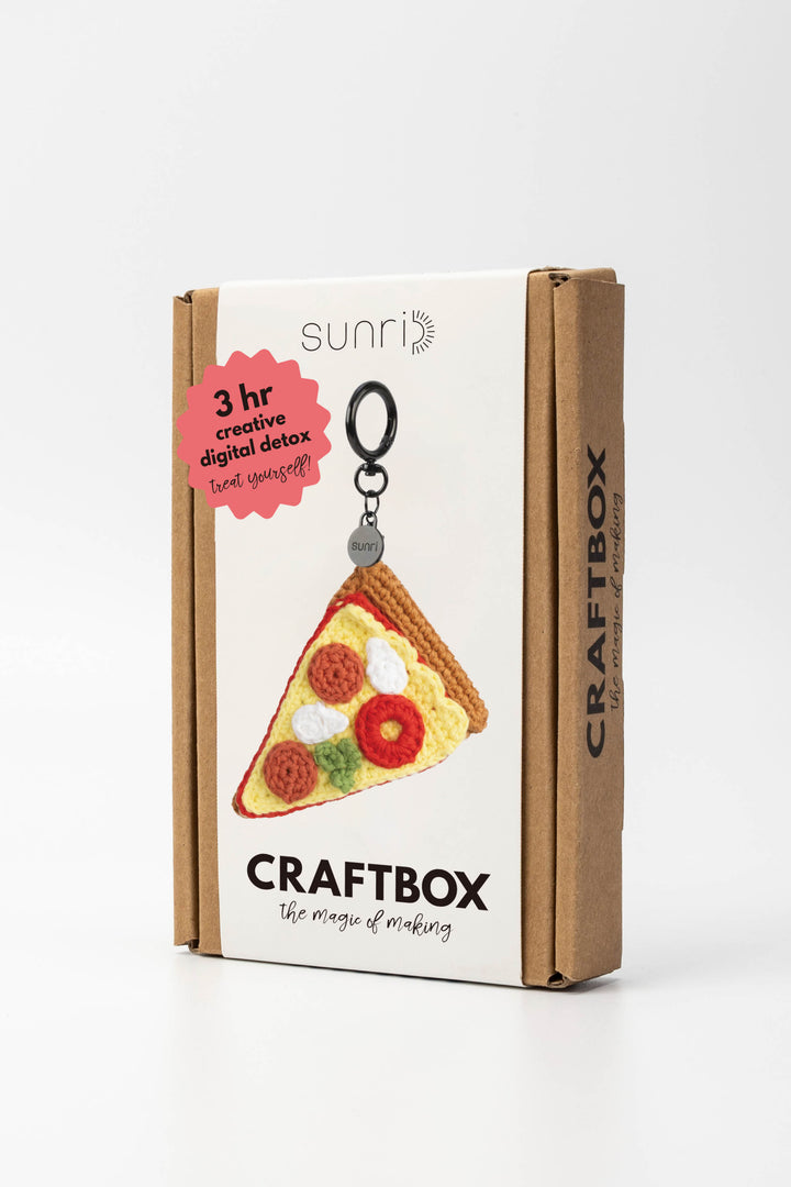 Craft box packaging with pizza slice keychain design on a white background