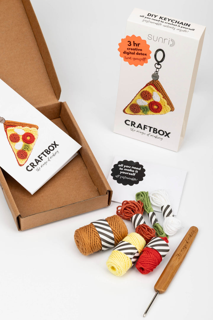 Craftbox with yarn and crochet hook on a white background