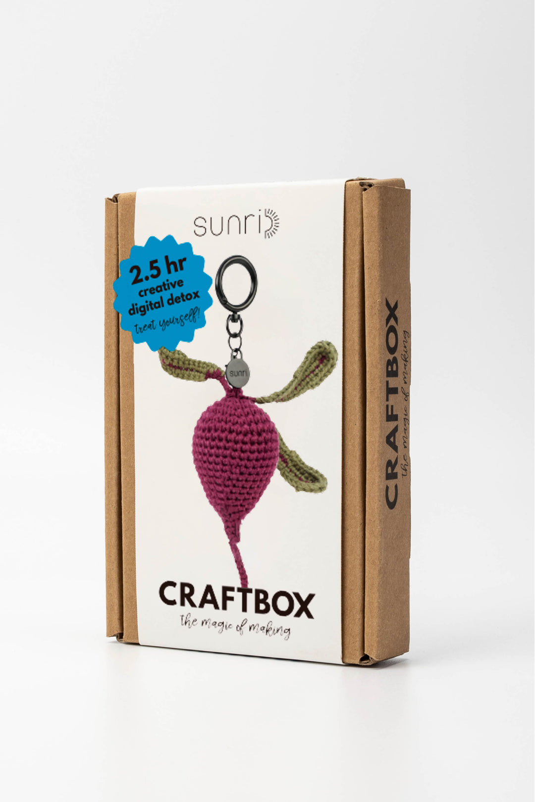 Craft box with a beetroot crochet keychain and 'sunri' branding on a white background