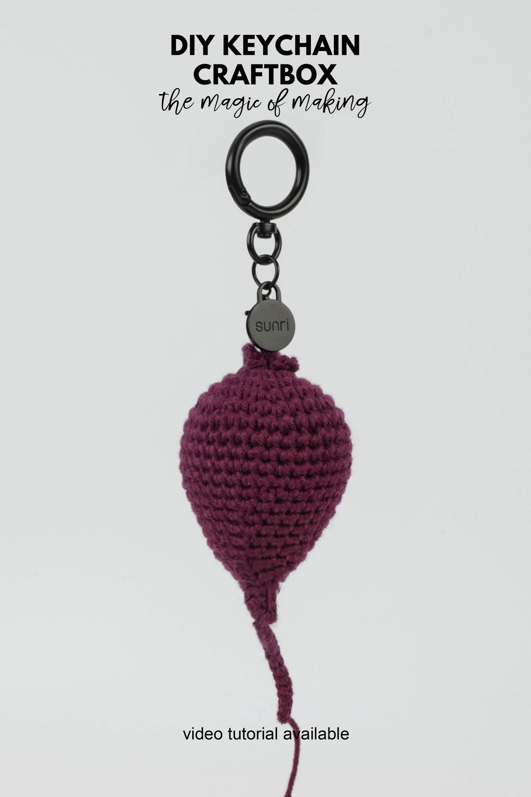Crocheted keychain with a purple beetroot-shaped pendant on a white background, featuring text about DIY keychain craftbox.