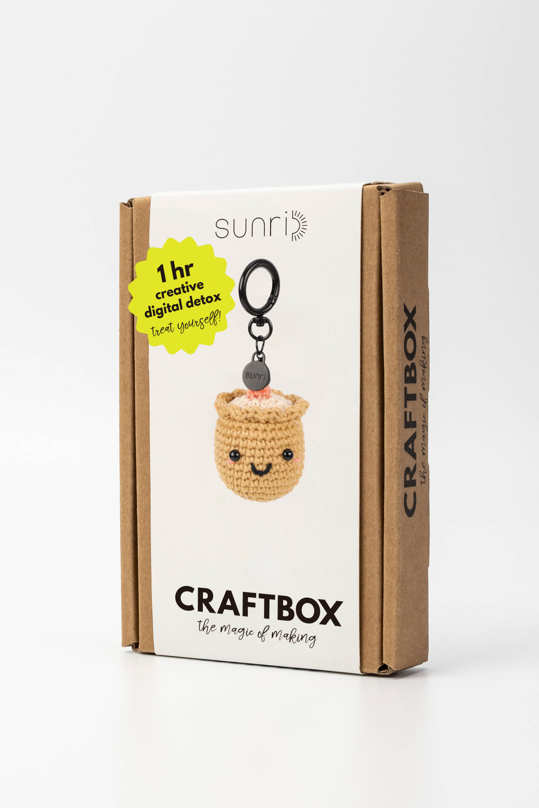 Craft box packaging with a small crochet sushi keychain on a white background