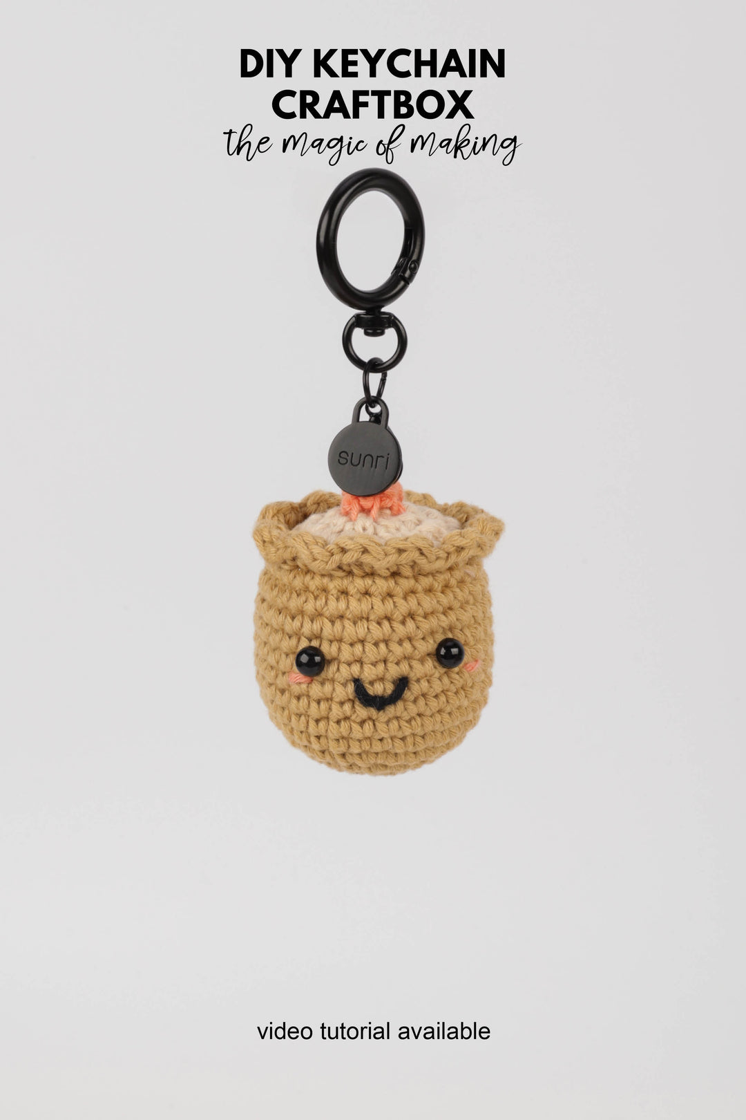 Crocheted sushi keychain with a smiling face on a white background, featuring 'DIY Keychain Craftbox' text.