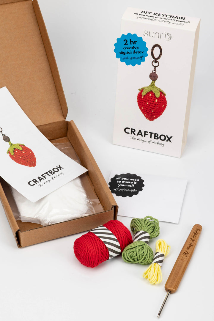 Craftbox with yarn and crochet hook on a white background