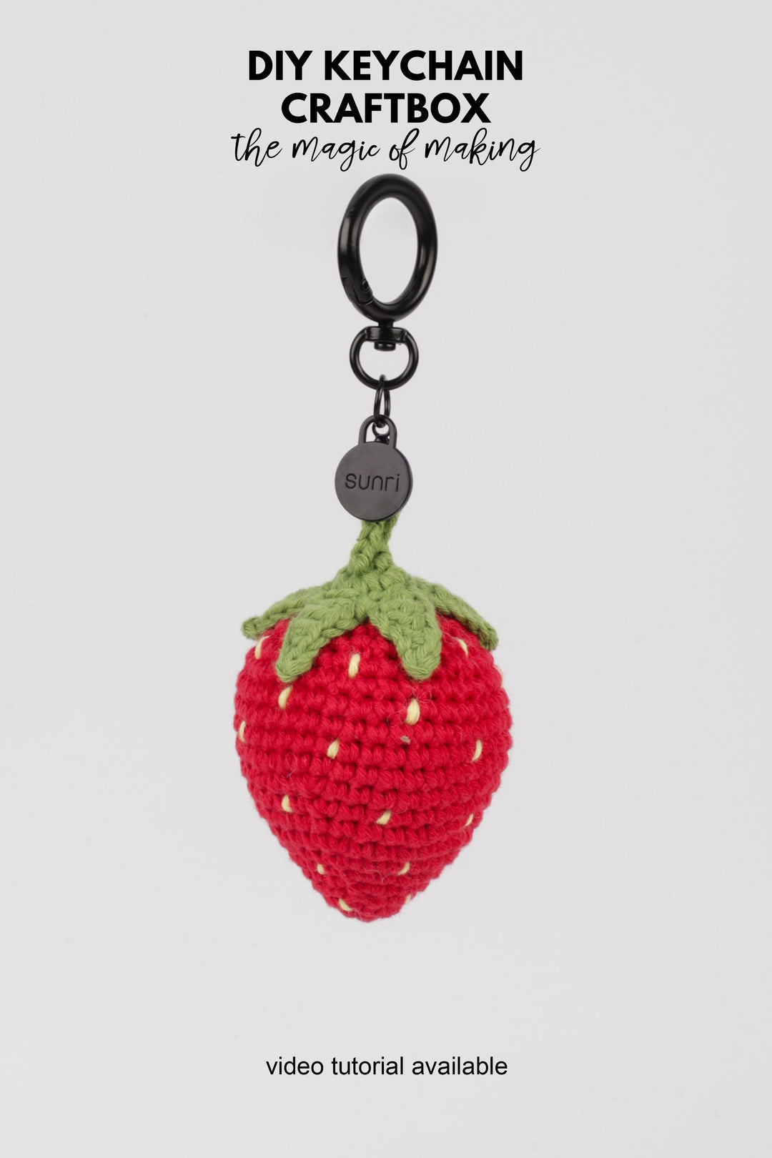 Crocheted strawberry keychain with a black ring on a white background, featuring 'DIY Keychain Craftbox' text.