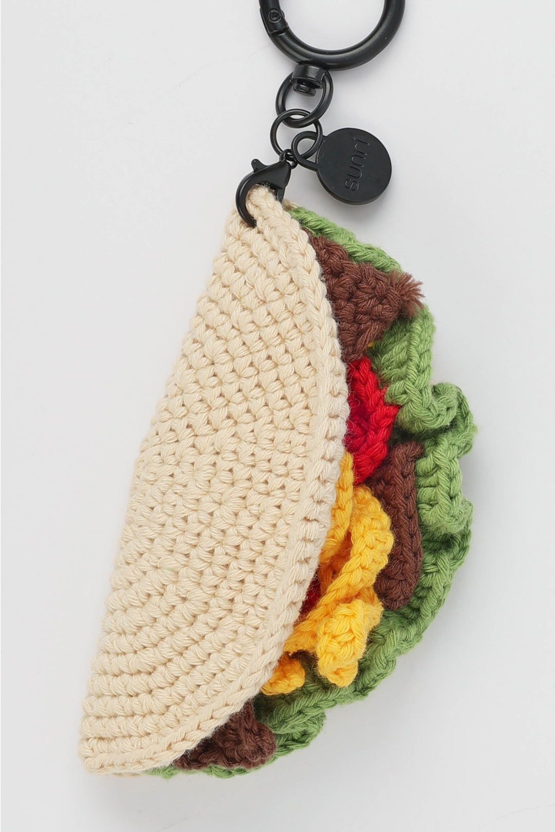Crocheted taco-shaped keychain with colorful layers on a white background