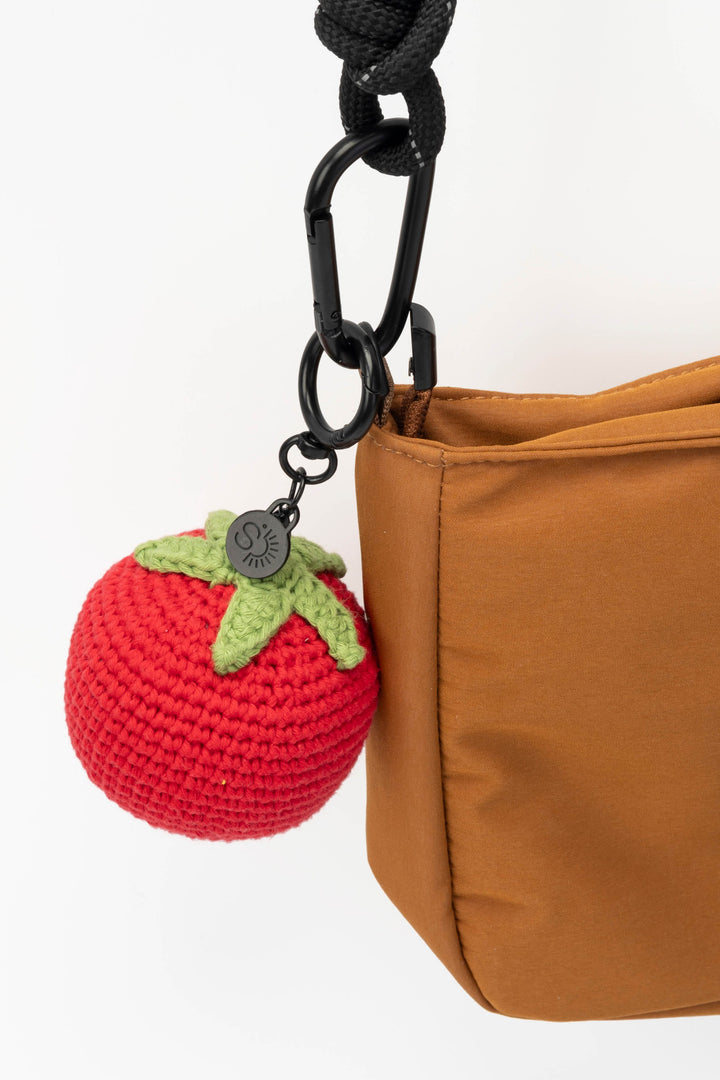 Brown bag with a crochet tomato keychain