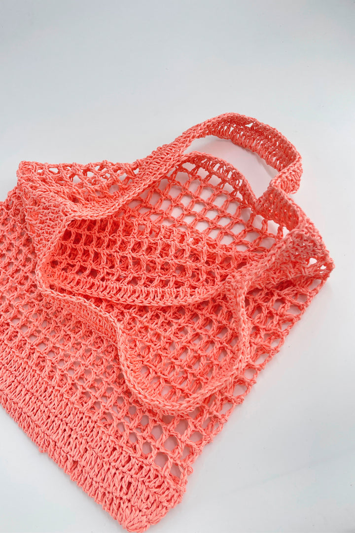 Pink crochet bag on a light gray background