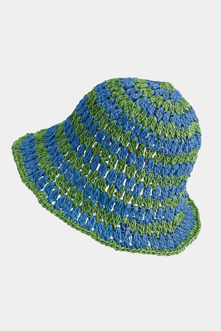 Blue and green striped crochet hat on a white background