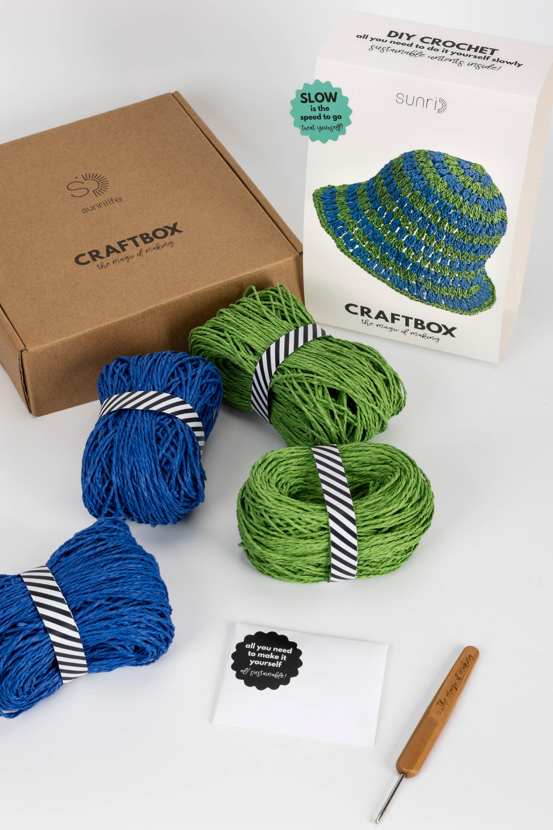 Craftbox with yarn and crochet hook on a white background