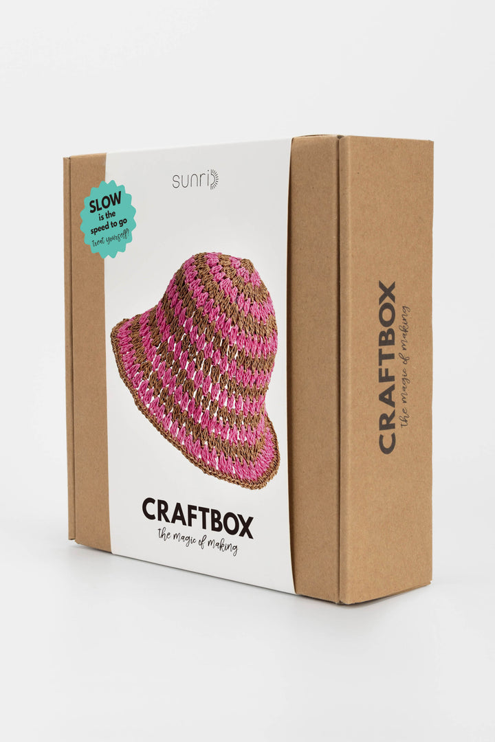 Craftbox packaging with a pink and gold beaded hat on a white background