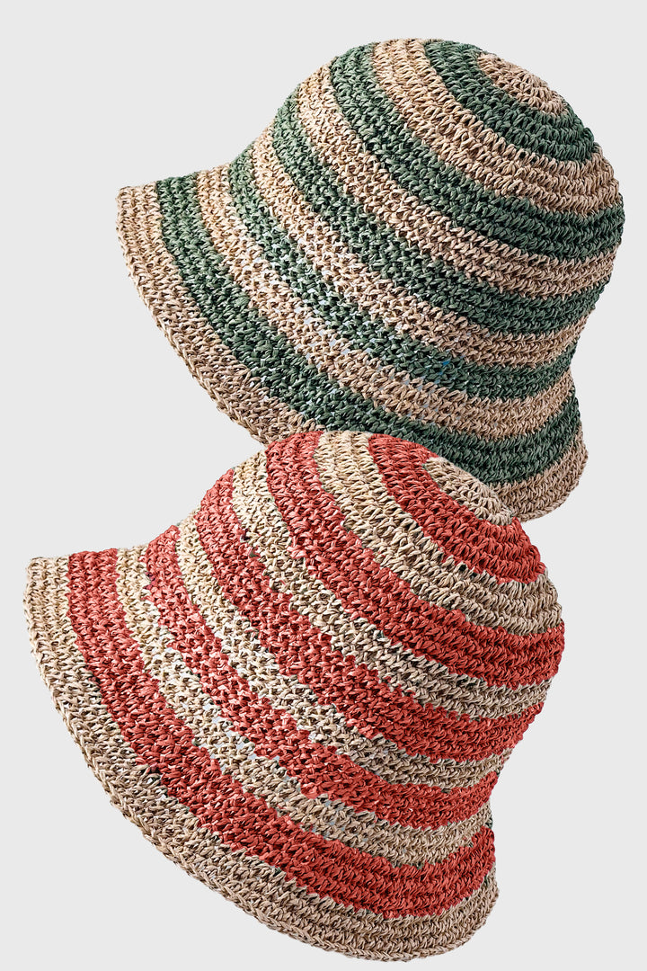 Striped straw hat with green, beige, and red pattern on a white background
