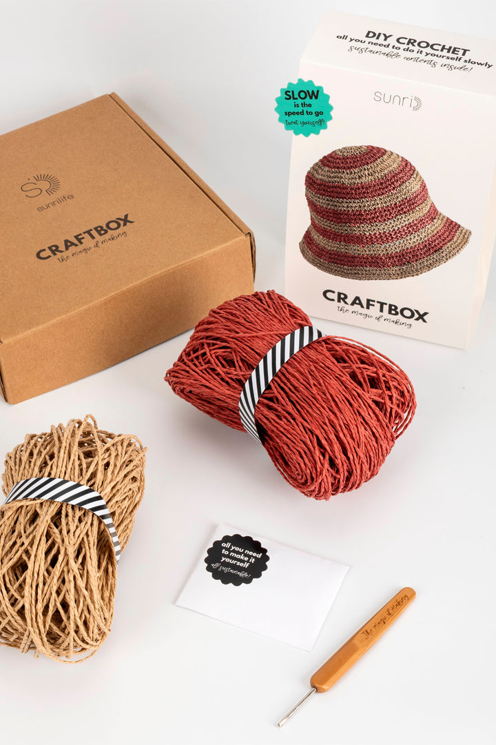 Craftbox crochet kit with yarn, hook, and pattern on a white background